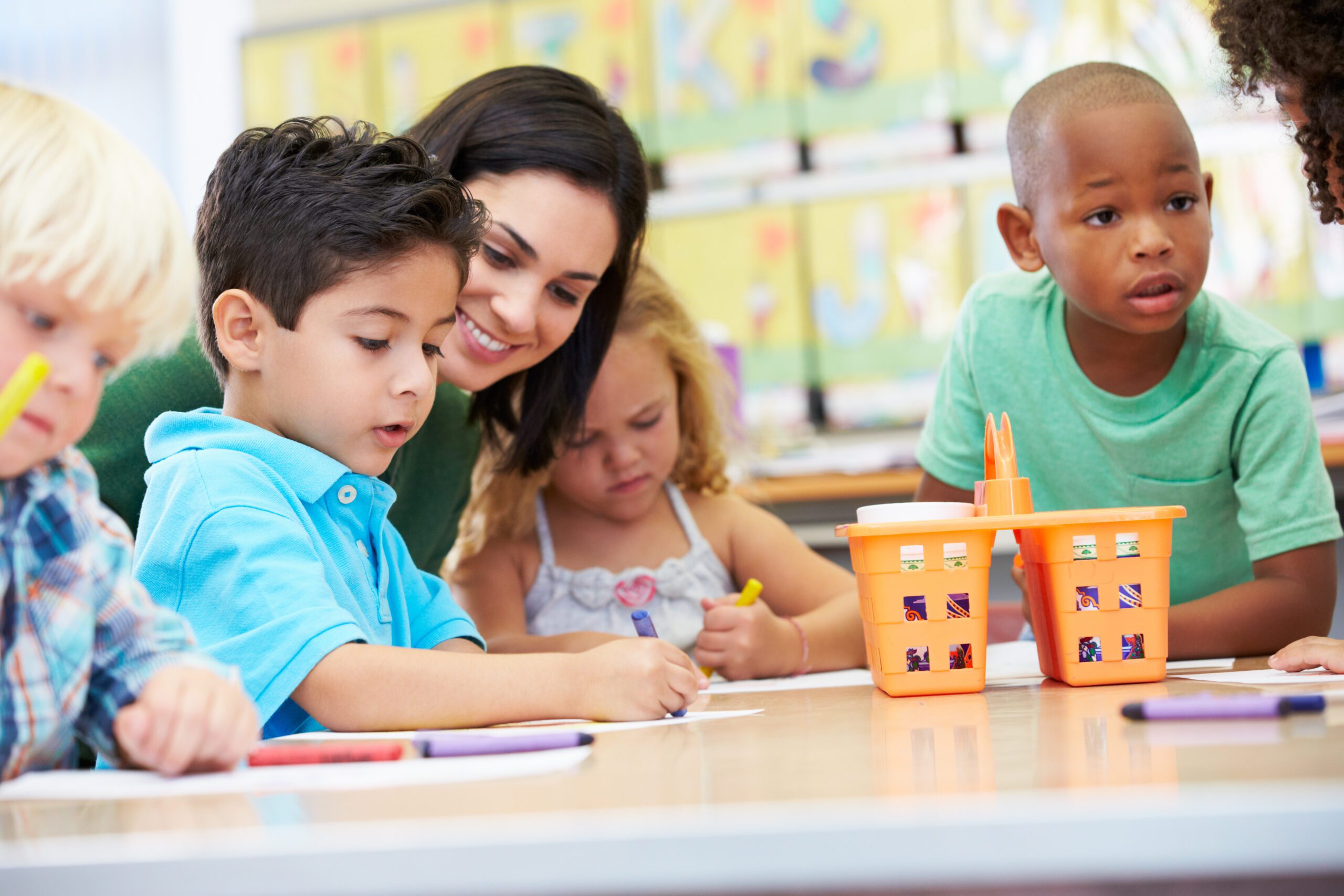 Group Of Elementary Age Children In Art Class With Teacher