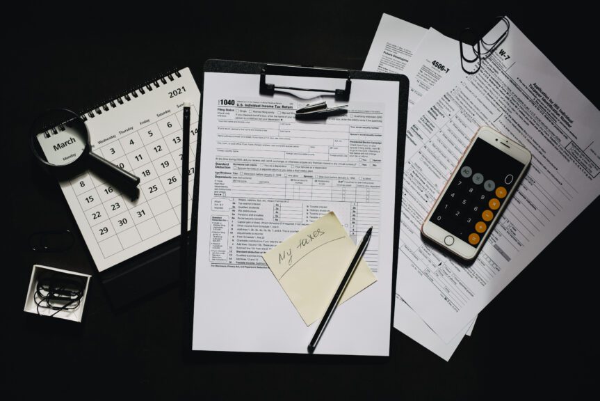 Sticky note on a clipboard with a tax form