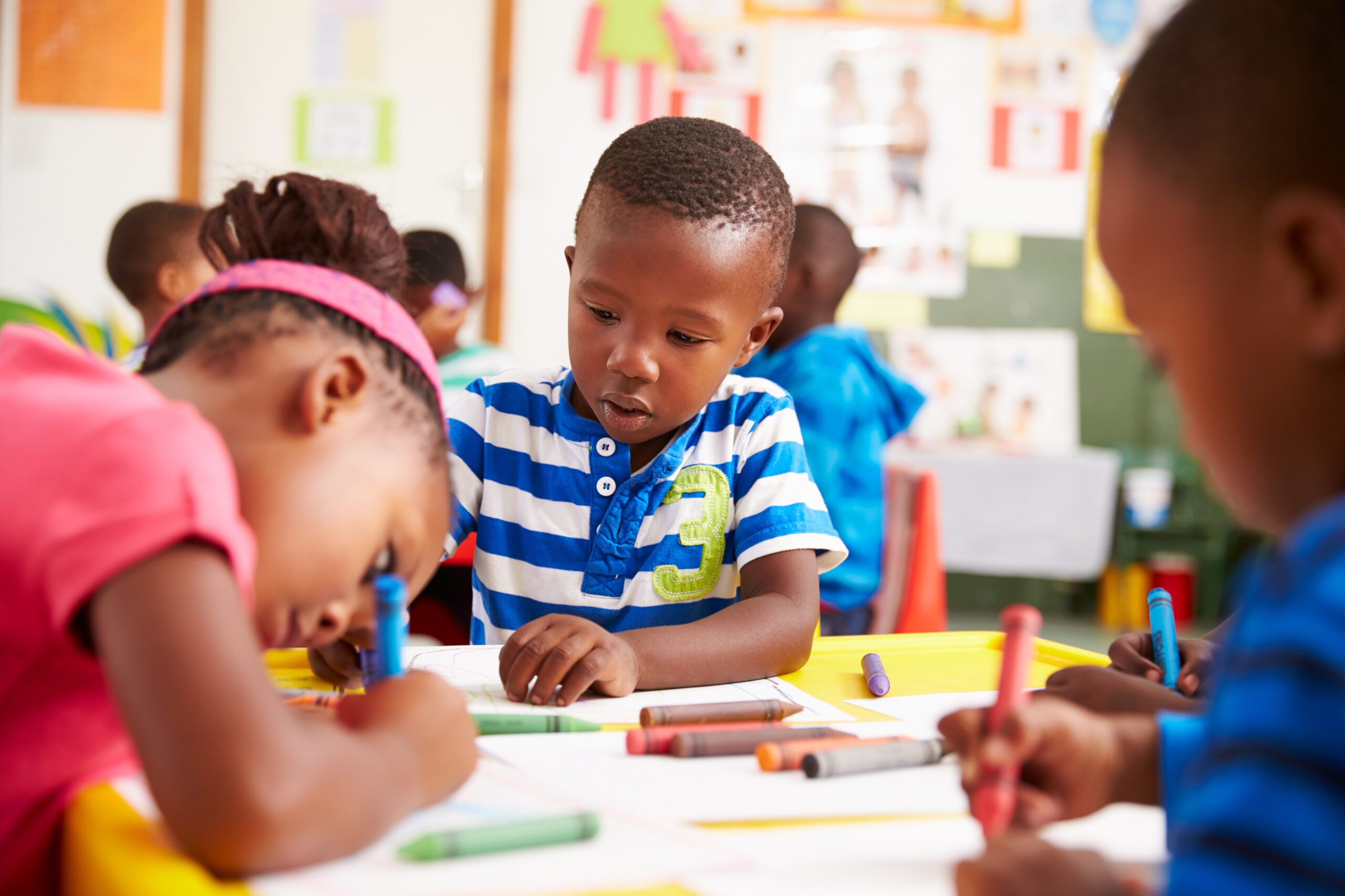 Group Of Elementary Age Children In Art Class With Teacher