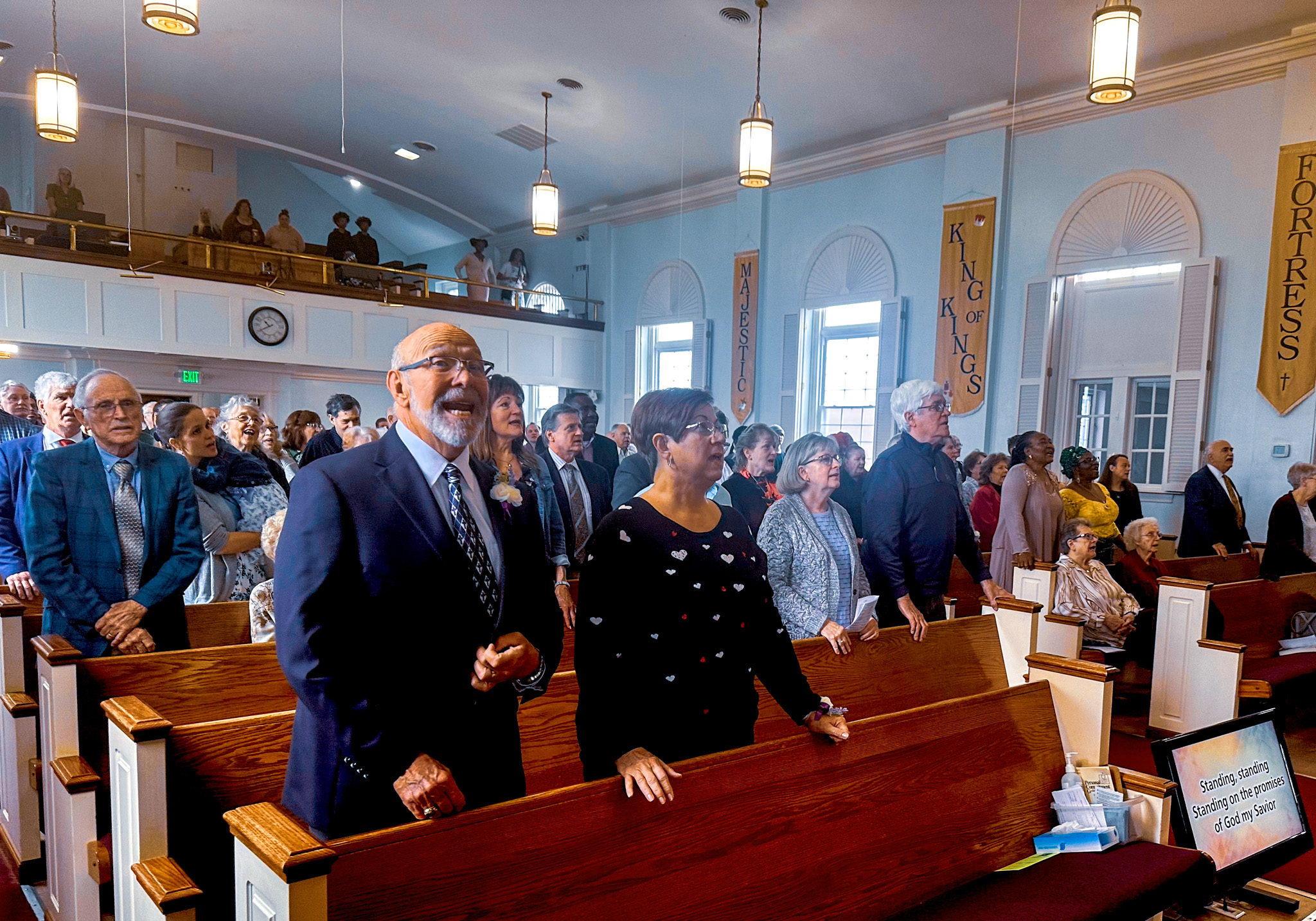 Top view of hand holding teal ribbon on dark background with copy space. Cervical and ovarian cancer, sexual assault, pcos, ptsd, anxiety disorder, agoraphobia and scleroderma awareness concept.