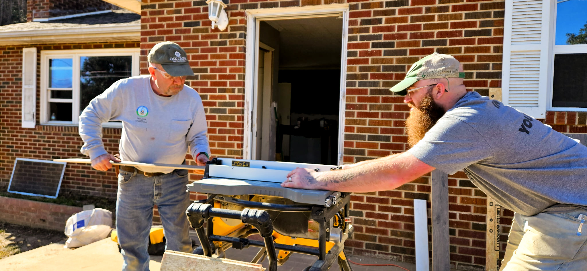 Top view of hand holding teal ribbon on dark background with copy space. Cervical and ovarian cancer, sexual assault, pcos, ptsd, anxiety disorder, agoraphobia and scleroderma awareness concept.