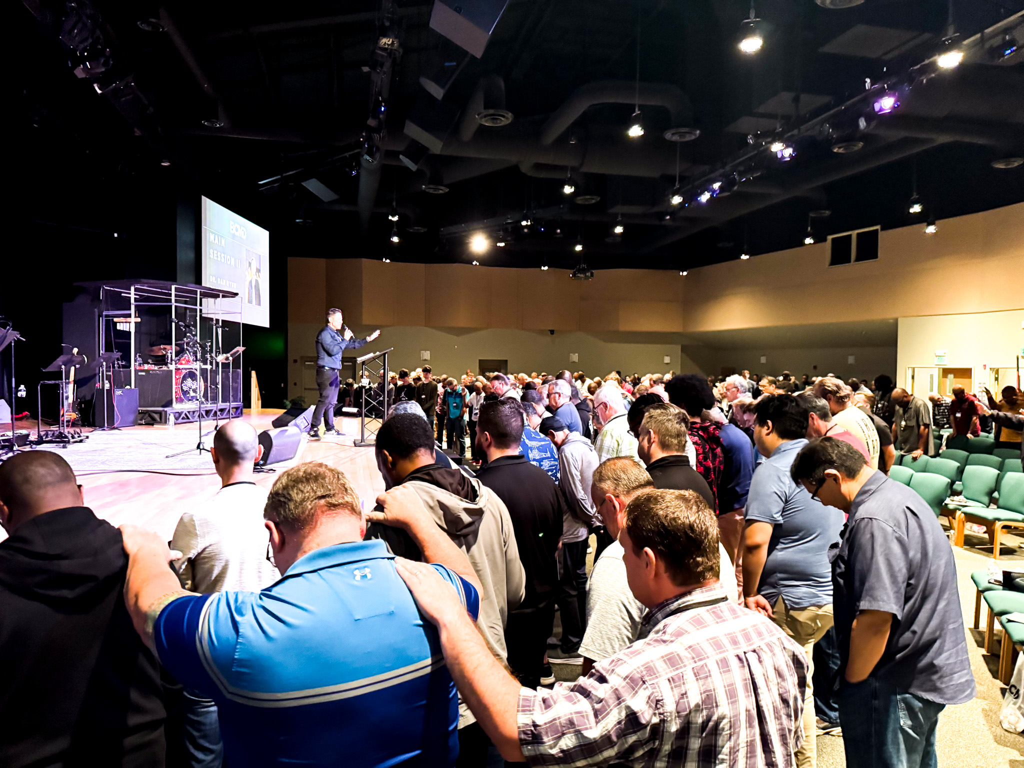 Top view of hand holding teal ribbon on dark background with copy space. Cervical and ovarian cancer, sexual assault, pcos, ptsd, anxiety disorder, agoraphobia and scleroderma awareness concept.