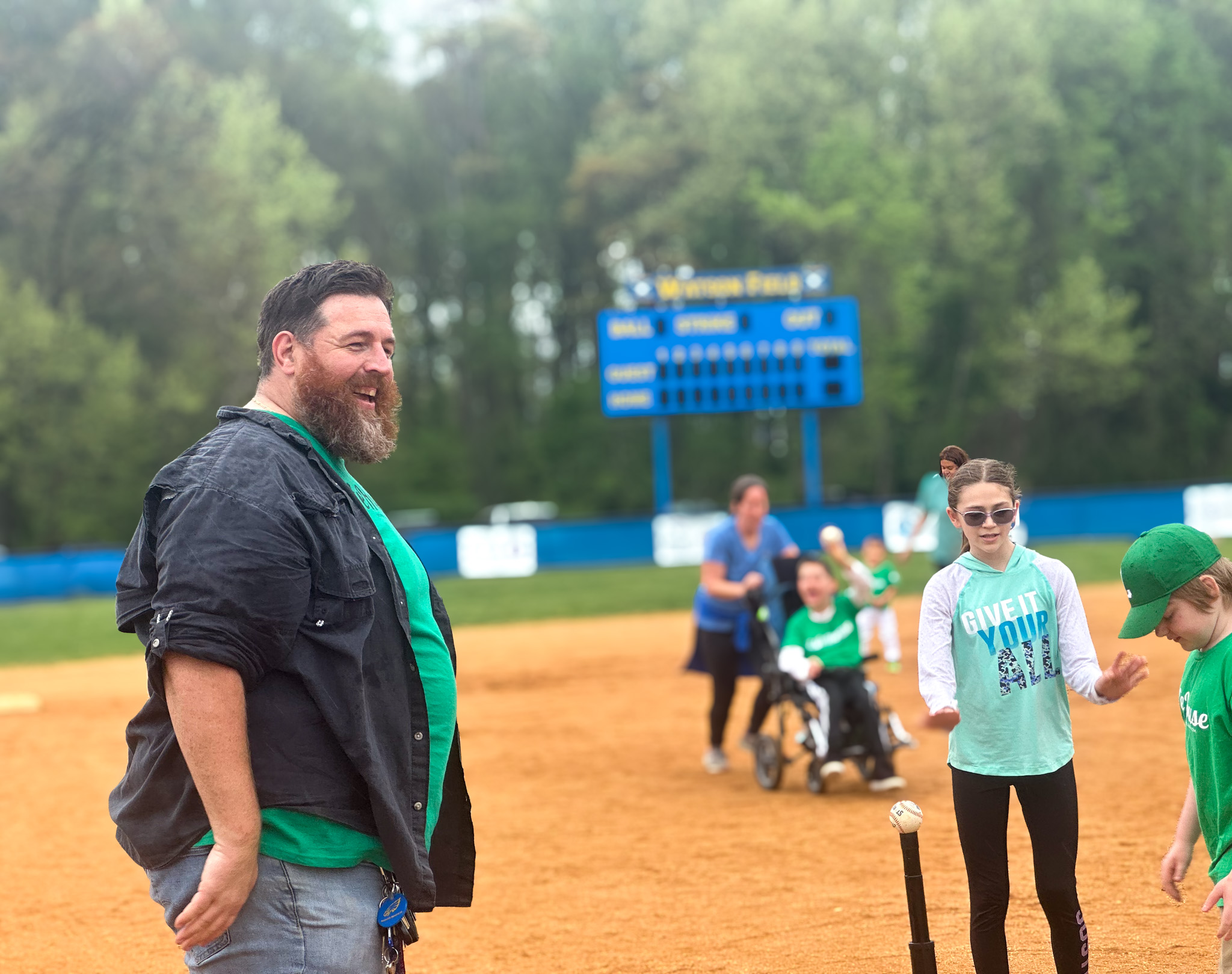 Top view of hand holding teal ribbon on dark background with copy space. Cervical and ovarian cancer, sexual assault, pcos, ptsd, anxiety disorder, agoraphobia and scleroderma awareness concept.