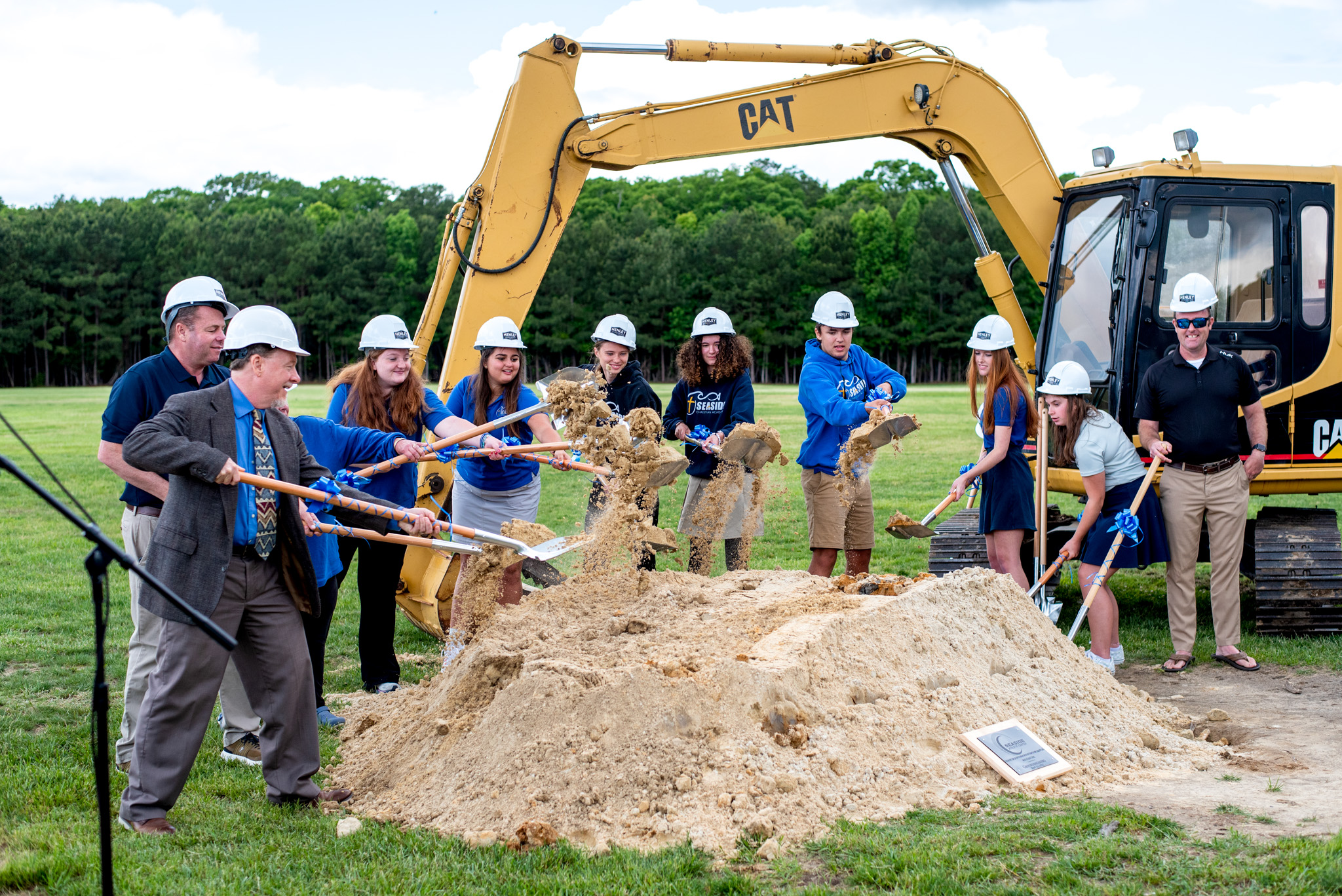 Top view of hand holding teal ribbon on dark background with copy space. Cervical and ovarian cancer, sexual assault, pcos, ptsd, anxiety disorder, agoraphobia and scleroderma awareness concept.