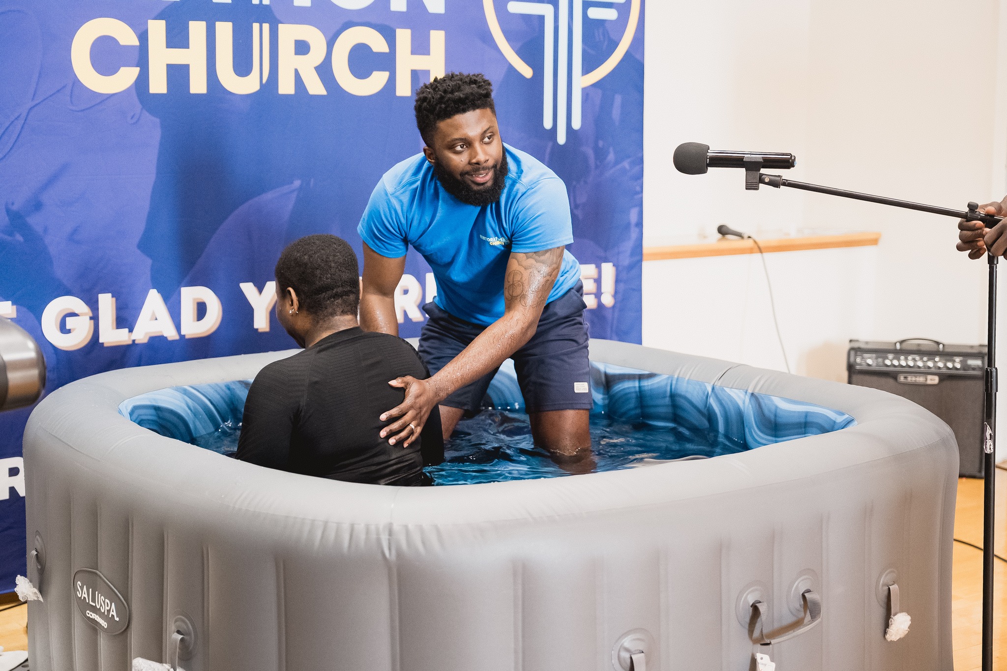 Top view of hand holding teal ribbon on dark background with copy space. Cervical and ovarian cancer, sexual assault, pcos, ptsd, anxiety disorder, agoraphobia and scleroderma awareness concept.