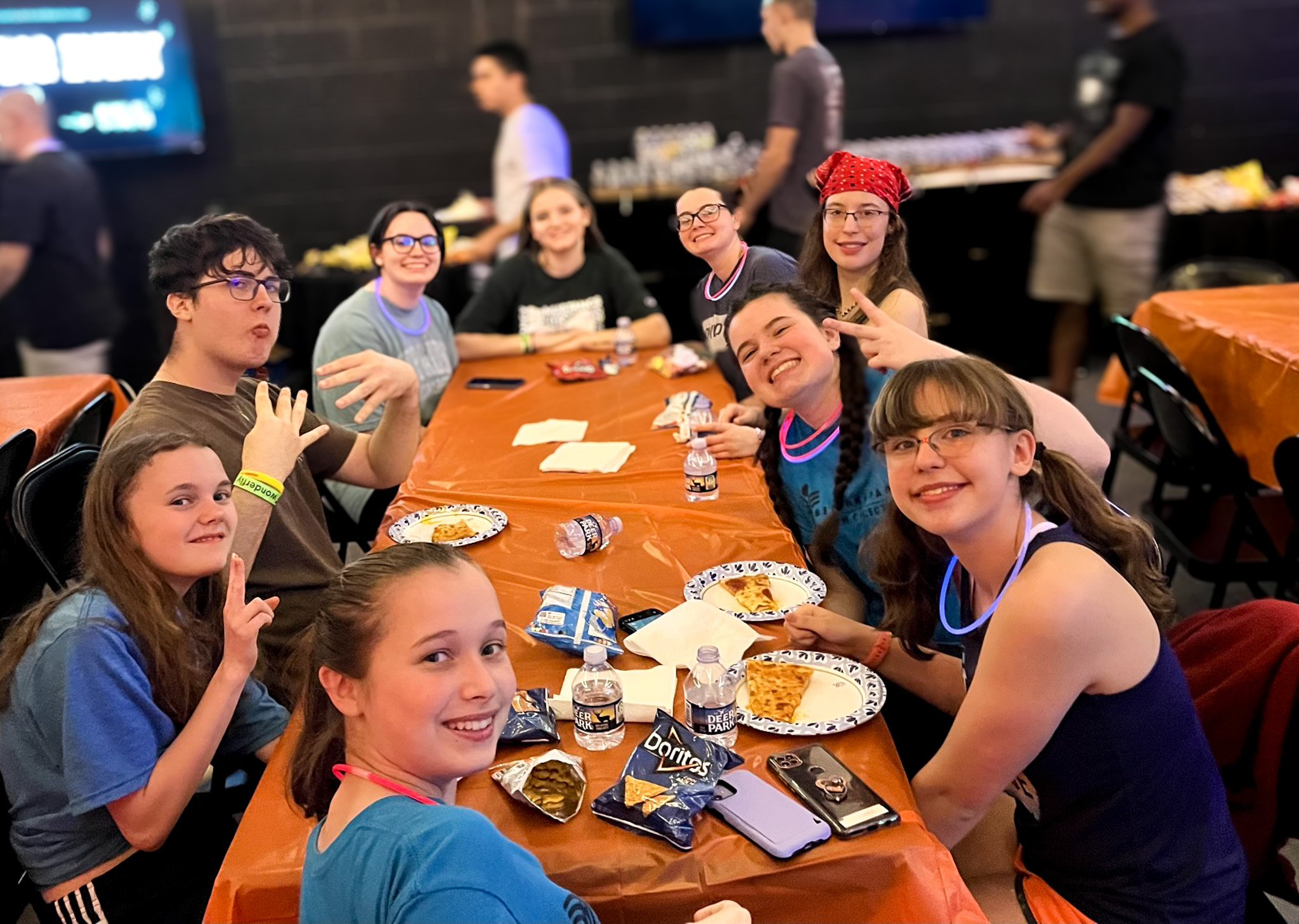 Top view of hand holding teal ribbon on dark background with copy space. Cervical and ovarian cancer, sexual assault, pcos, ptsd, anxiety disorder, agoraphobia and scleroderma awareness concept.