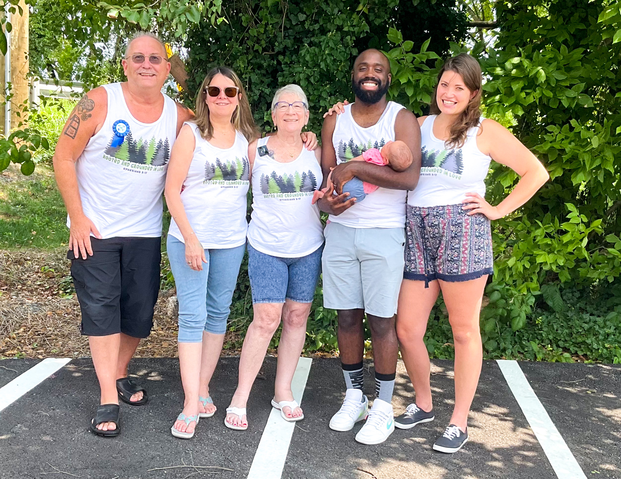 Top view of hand holding teal ribbon on dark background with copy space. Cervical and ovarian cancer, sexual assault, pcos, ptsd, anxiety disorder, agoraphobia and scleroderma awareness concept.