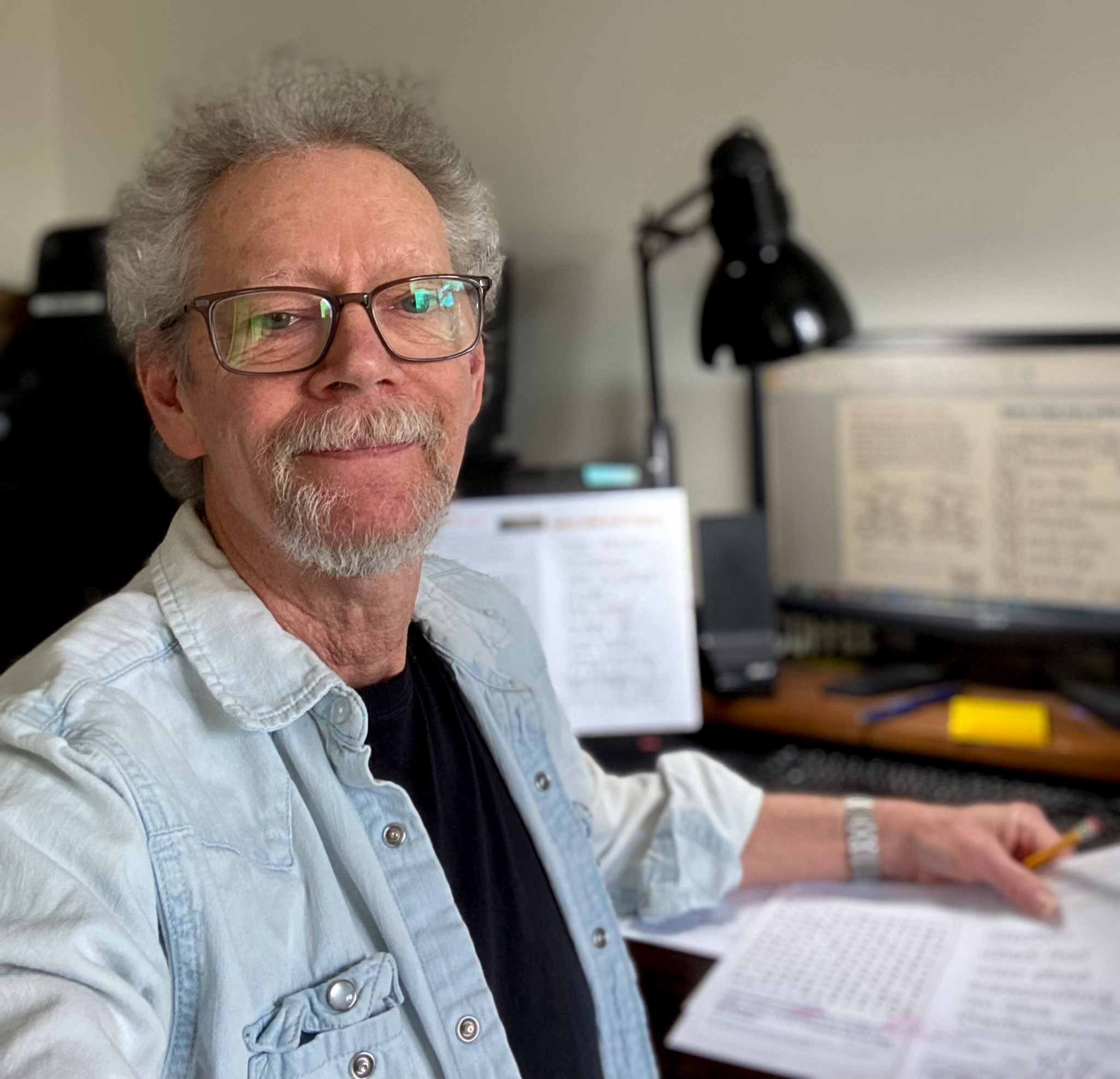 Top view of hand holding teal ribbon on dark background with copy space. Cervical and ovarian cancer, sexual assault, pcos, ptsd, anxiety disorder, agoraphobia and scleroderma awareness concept.