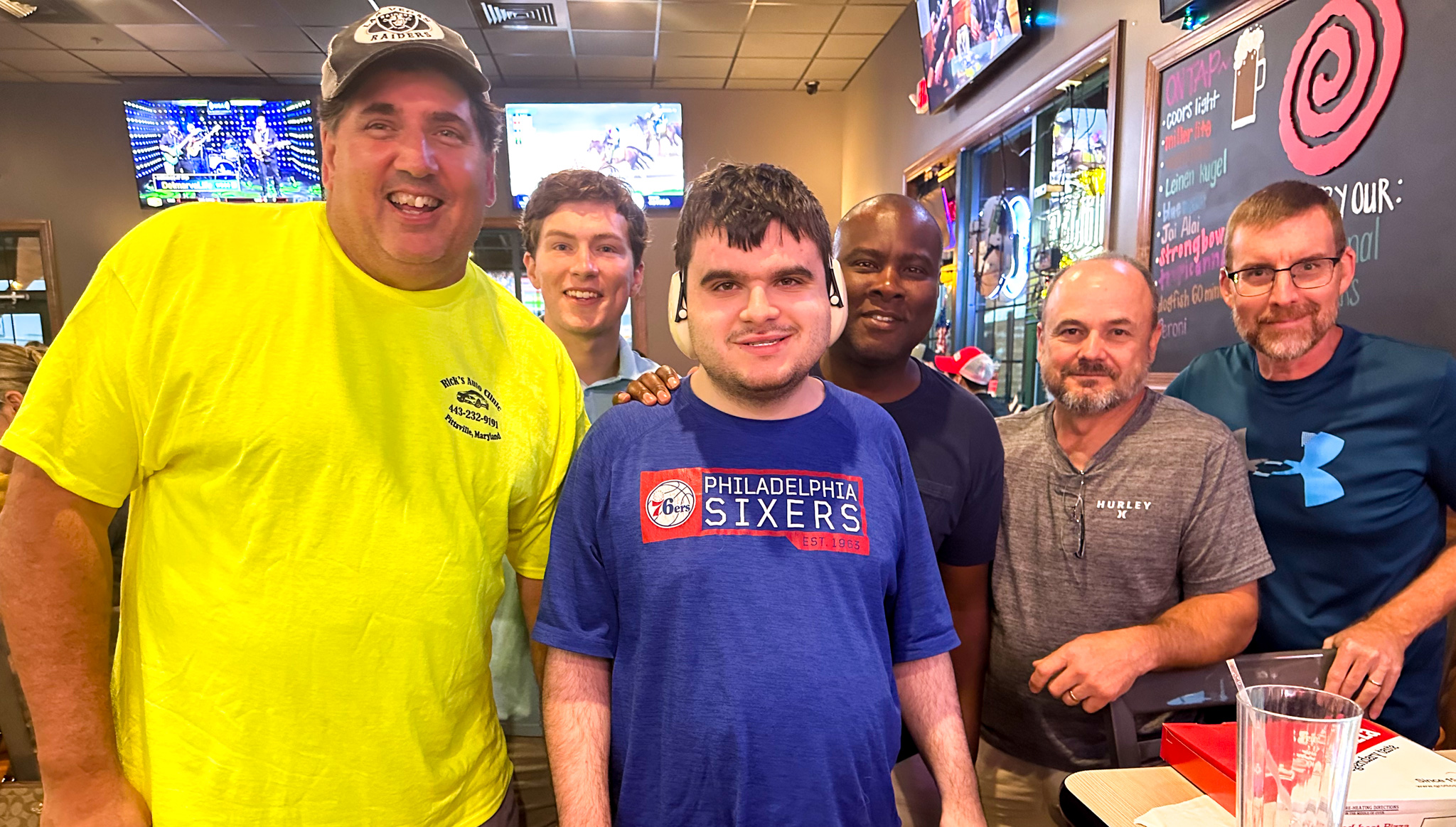 Top view of hand holding teal ribbon on dark background with copy space. Cervical and ovarian cancer, sexual assault, pcos, ptsd, anxiety disorder, agoraphobia and scleroderma awareness concept.