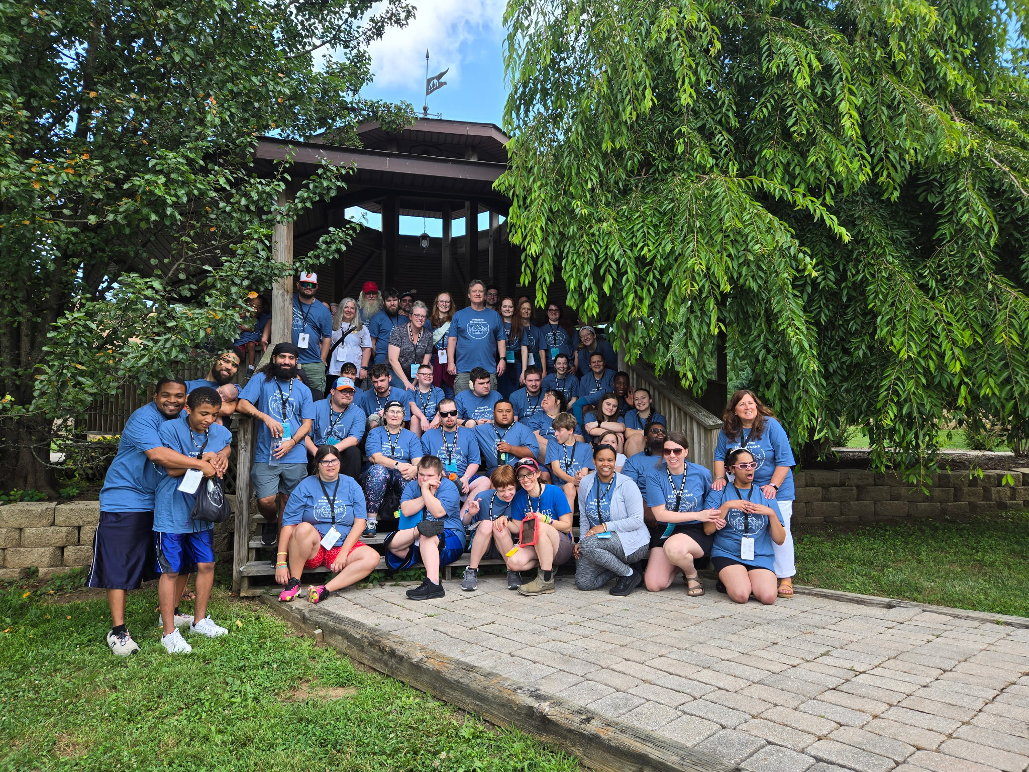 Top view of hand holding teal ribbon on dark background with copy space. Cervical and ovarian cancer, sexual assault, pcos, ptsd, anxiety disorder, agoraphobia and scleroderma awareness concept.
