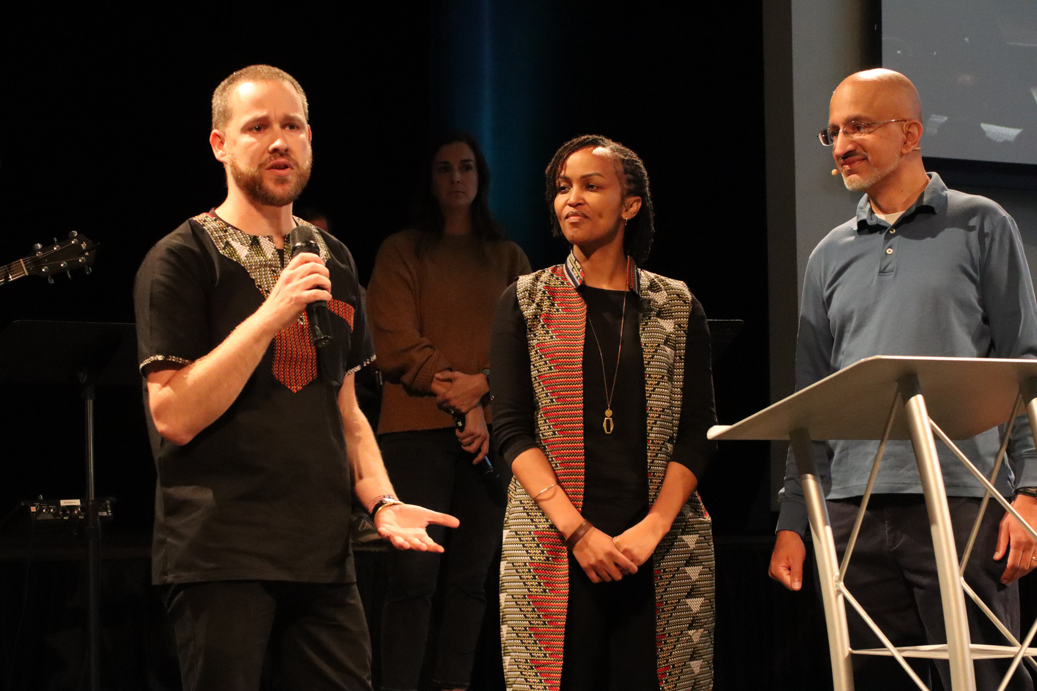 Top view of hand holding teal ribbon on dark background with copy space. Cervical and ovarian cancer, sexual assault, pcos, ptsd, anxiety disorder, agoraphobia and scleroderma awareness concept.