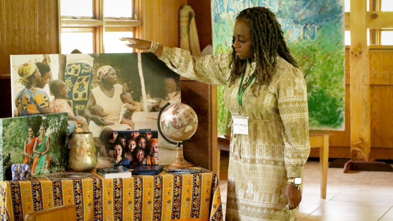 Top view of hand holding teal ribbon on dark background with copy space. Cervical and ovarian cancer, sexual assault, pcos, ptsd, anxiety disorder, agoraphobia and scleroderma awareness concept.