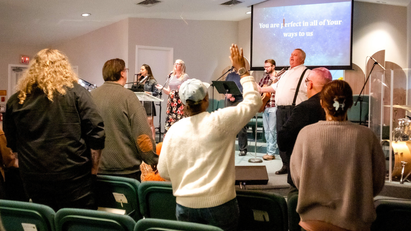 Top view of hand holding teal ribbon on dark background with copy space. Cervical and ovarian cancer, sexual assault, pcos, ptsd, anxiety disorder, agoraphobia and scleroderma awareness concept.