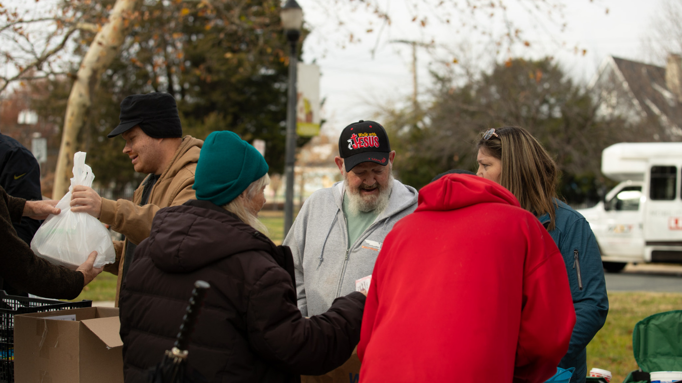 Top view of hand holding teal ribbon on dark background with copy space. Cervical and ovarian cancer, sexual assault, pcos, ptsd, anxiety disorder, agoraphobia and scleroderma awareness concept.