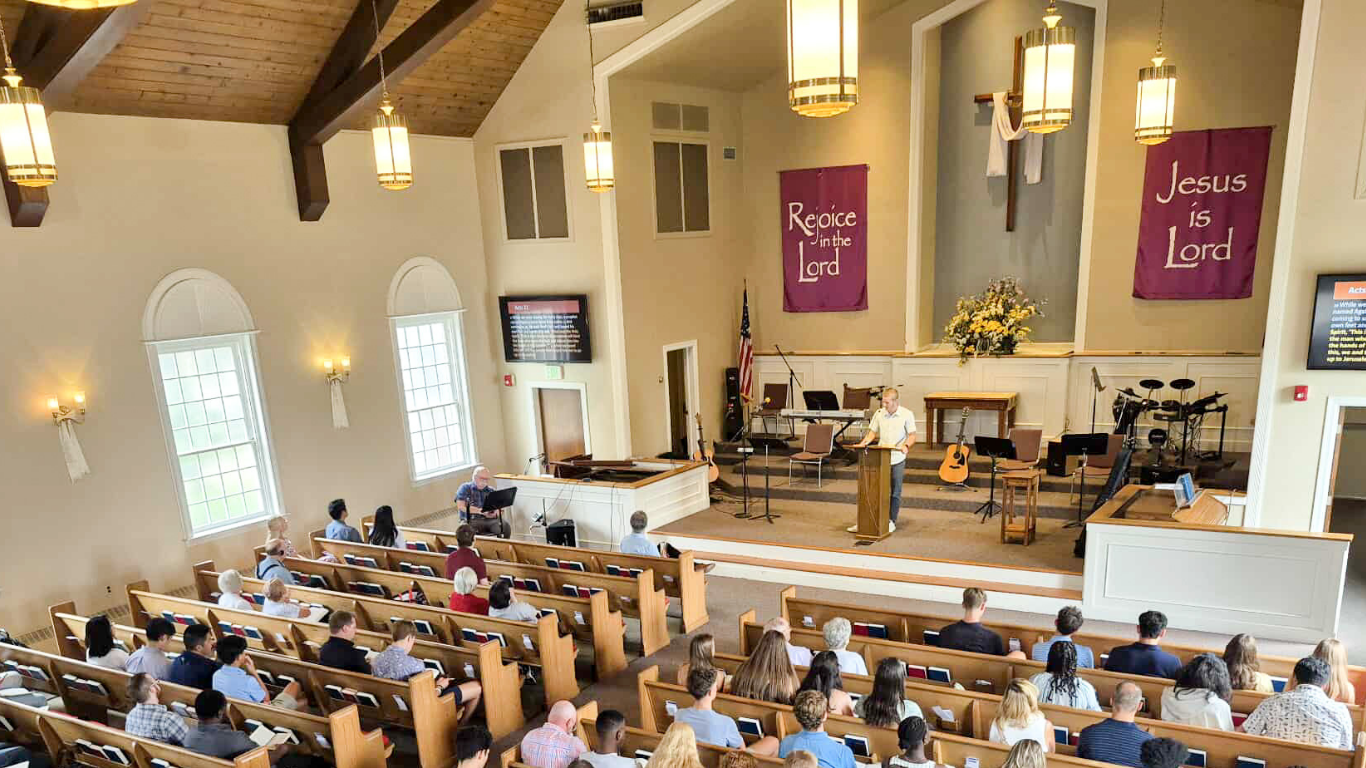 Top view of hand holding teal ribbon on dark background with copy space. Cervical and ovarian cancer, sexual assault, pcos, ptsd, anxiety disorder, agoraphobia and scleroderma awareness concept.