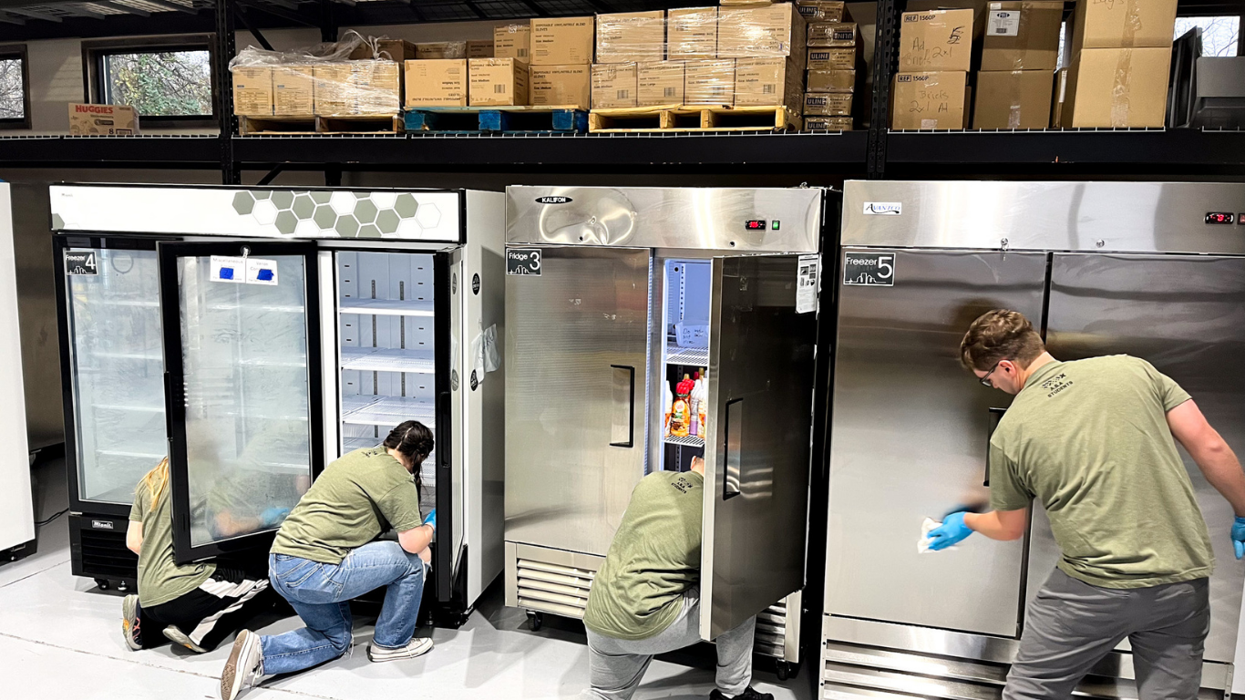 Top view of hand holding teal ribbon on dark background with copy space. Cervical and ovarian cancer, sexual assault, pcos, ptsd, anxiety disorder, agoraphobia and scleroderma awareness concept.