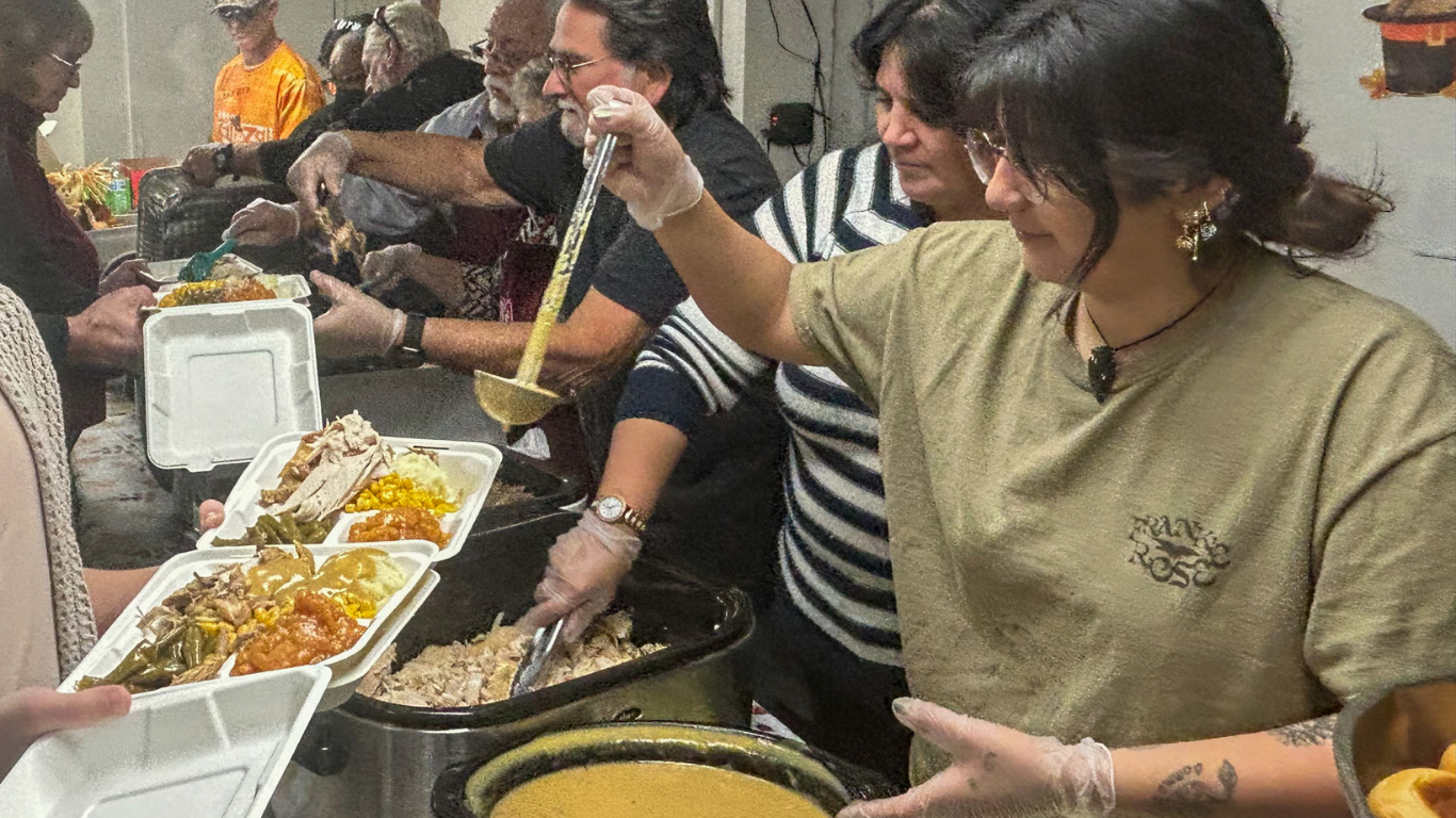 Top view of hand holding teal ribbon on dark background with copy space. Cervical and ovarian cancer, sexual assault, pcos, ptsd, anxiety disorder, agoraphobia and scleroderma awareness concept.
