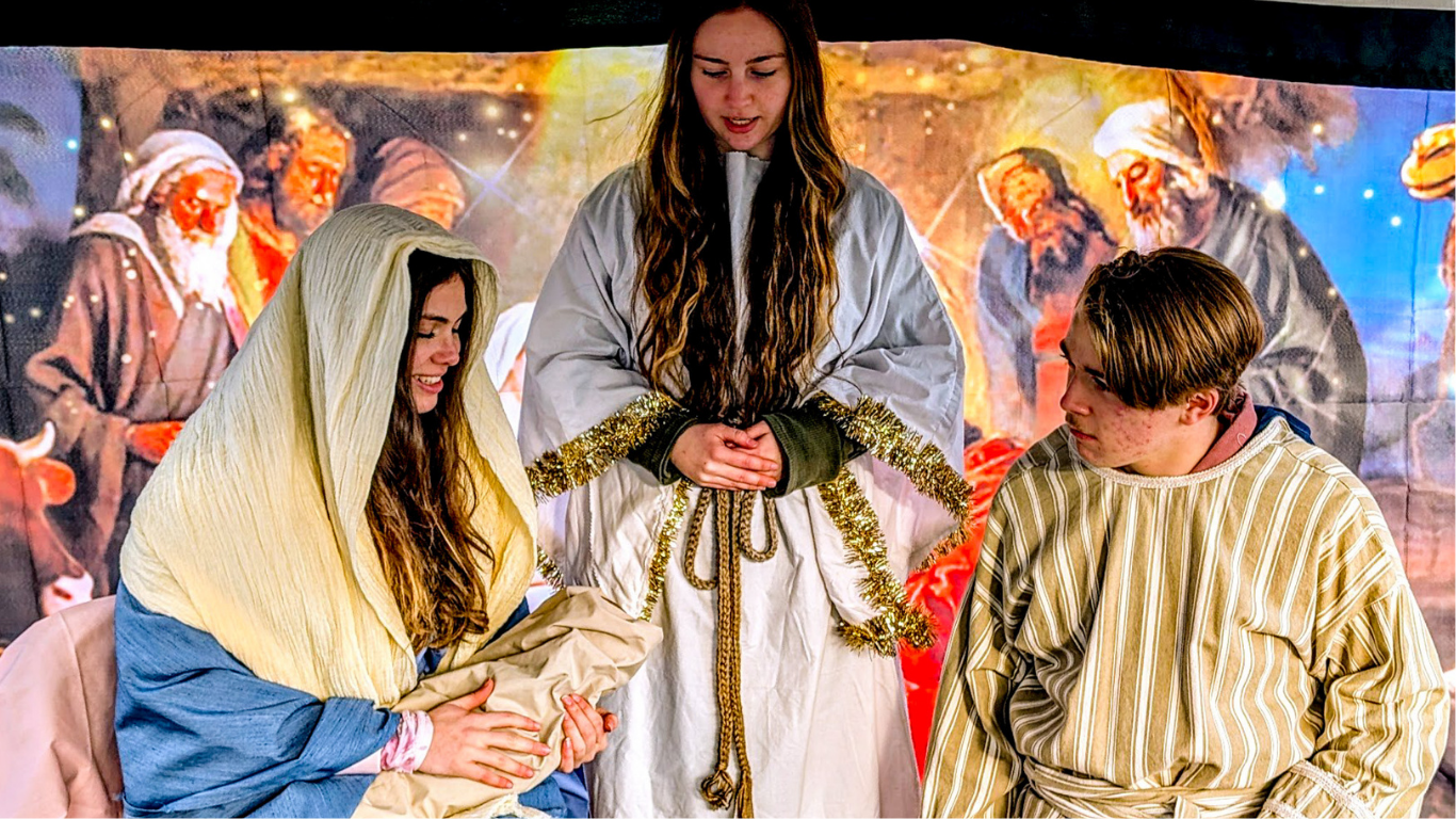 Top view of hand holding teal ribbon on dark background with copy space. Cervical and ovarian cancer, sexual assault, pcos, ptsd, anxiety disorder, agoraphobia and scleroderma awareness concept.