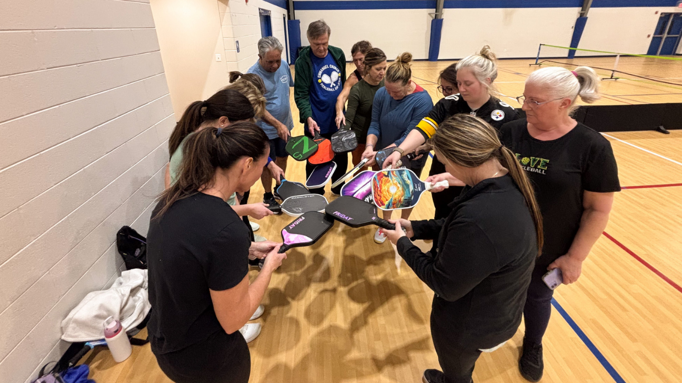 Top view of hand holding teal ribbon on dark background with copy space. Cervical and ovarian cancer, sexual assault, pcos, ptsd, anxiety disorder, agoraphobia and scleroderma awareness concept.