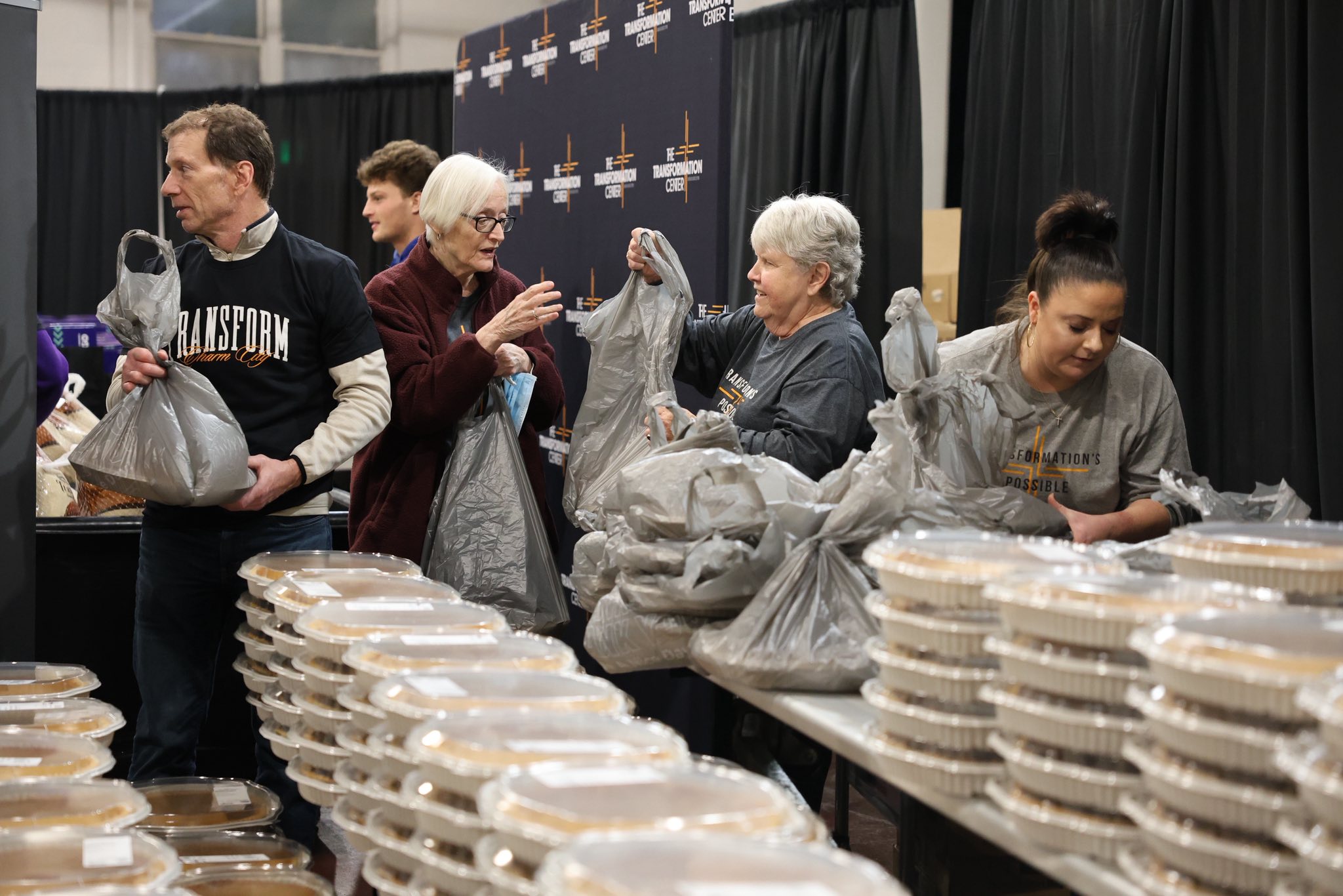Top view of hand holding teal ribbon on dark background with copy space. Cervical and ovarian cancer, sexual assault, pcos, ptsd, anxiety disorder, agoraphobia and scleroderma awareness concept.