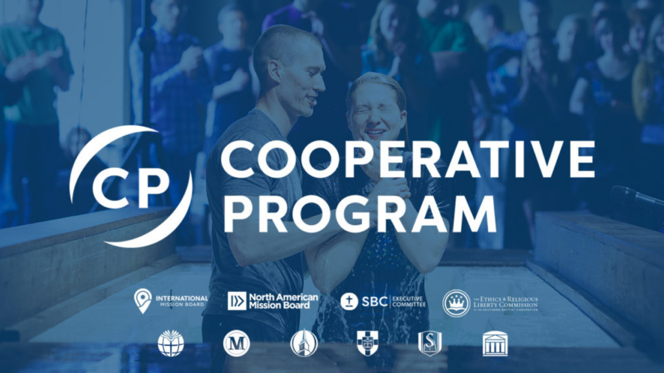 Top view of hand holding teal ribbon on dark background with copy space. Cervical and ovarian cancer, sexual assault, pcos, ptsd, anxiety disorder, agoraphobia and scleroderma awareness concept.