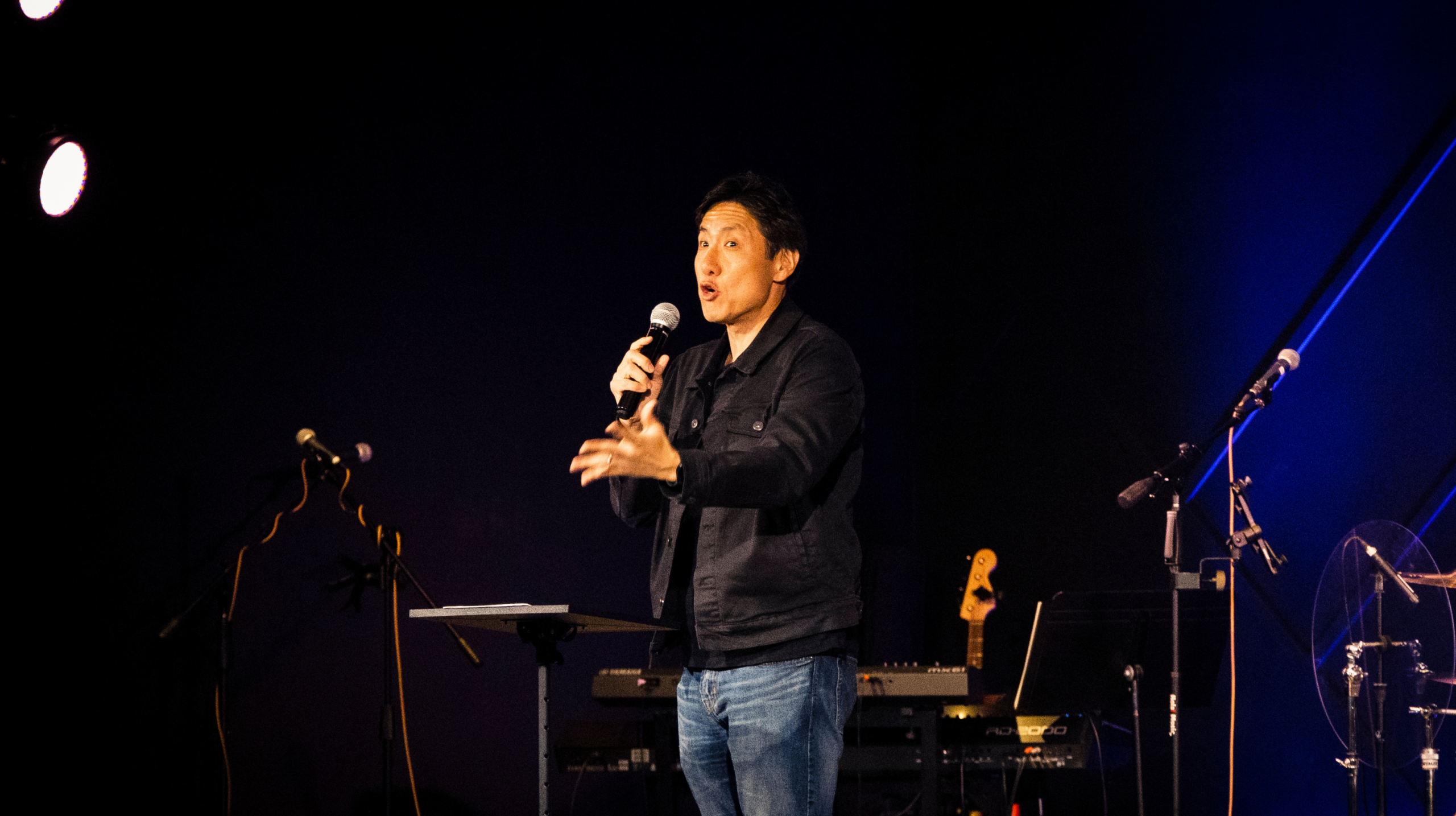 Top view of hand holding teal ribbon on dark background with copy space. Cervical and ovarian cancer, sexual assault, pcos, ptsd, anxiety disorder, agoraphobia and scleroderma awareness concept.