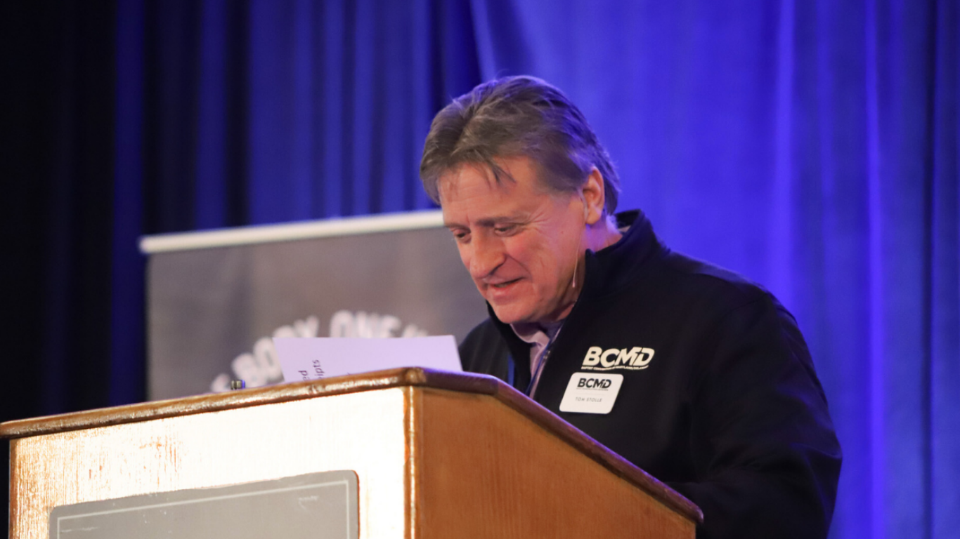 Top view of hand holding teal ribbon on dark background with copy space. Cervical and ovarian cancer, sexual assault, pcos, ptsd, anxiety disorder, agoraphobia and scleroderma awareness concept.