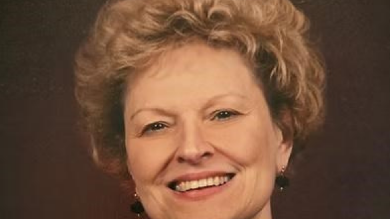 Top view of hand holding teal ribbon on dark background with copy space. Cervical and ovarian cancer, sexual assault, pcos, ptsd, anxiety disorder, agoraphobia and scleroderma awareness concept.