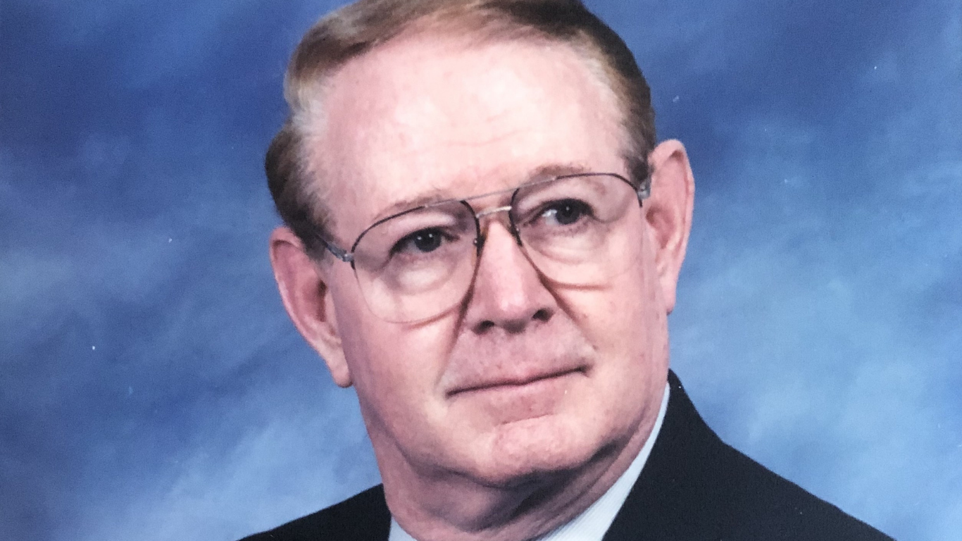 Top view of hand holding teal ribbon on dark background with copy space. Cervical and ovarian cancer, sexual assault, pcos, ptsd, anxiety disorder, agoraphobia and scleroderma awareness concept.