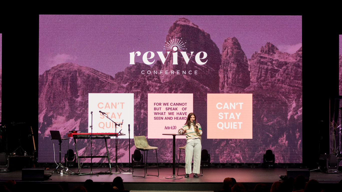 Top view of hand holding teal ribbon on dark background with copy space. Cervical and ovarian cancer, sexual assault, pcos, ptsd, anxiety disorder, agoraphobia and scleroderma awareness concept.