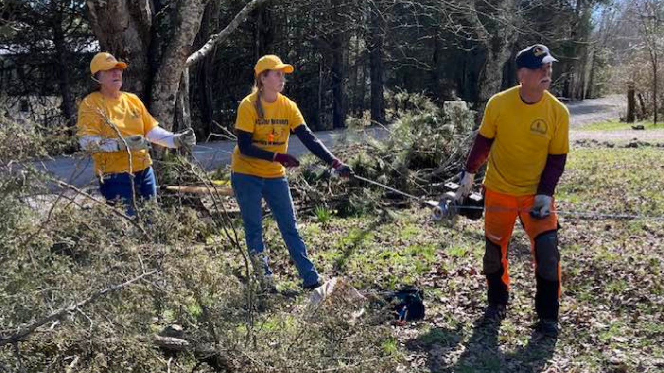 Top view of hand holding teal ribbon on dark background with copy space. Cervical and ovarian cancer, sexual assault, pcos, ptsd, anxiety disorder, agoraphobia and scleroderma awareness concept.