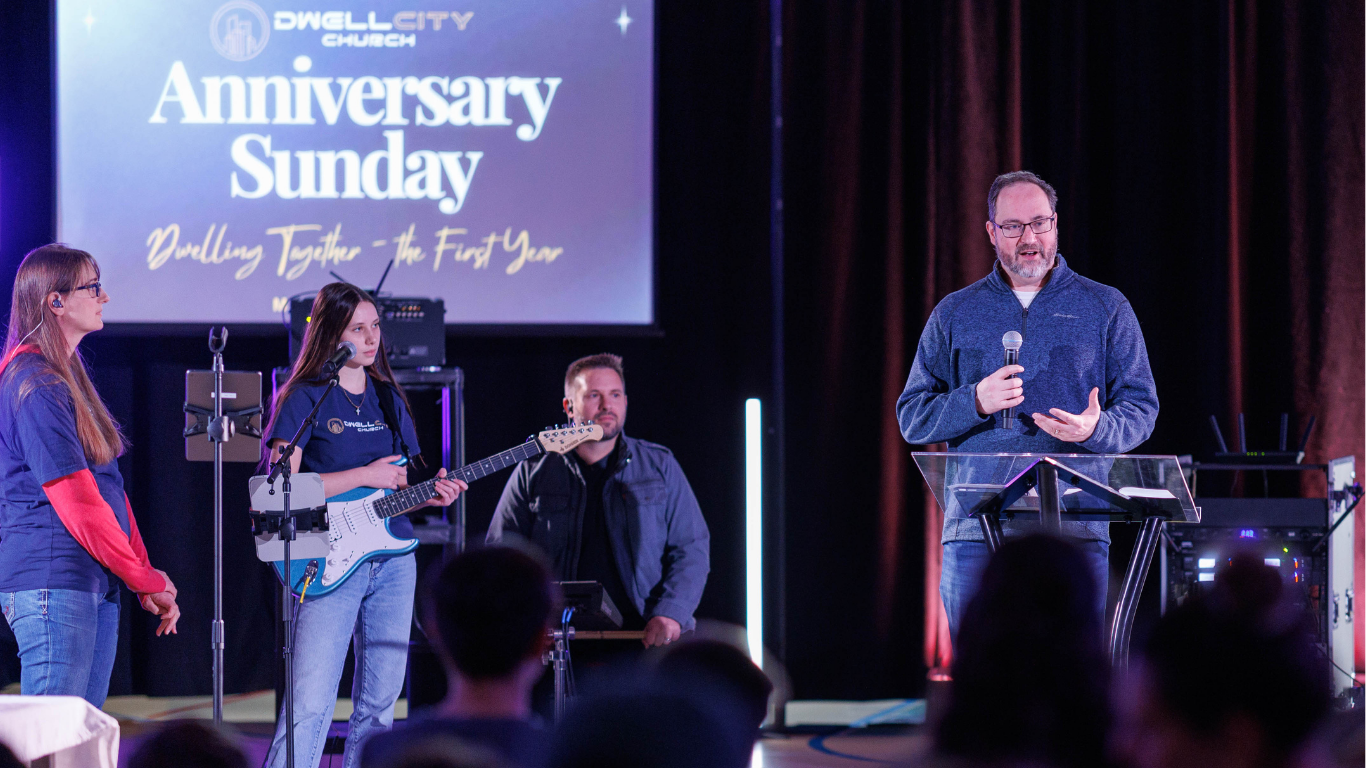 Top view of hand holding teal ribbon on dark background with copy space. Cervical and ovarian cancer, sexual assault, pcos, ptsd, anxiety disorder, agoraphobia and scleroderma awareness concept.