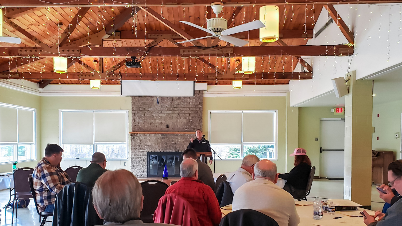 Top view of hand holding teal ribbon on dark background with copy space. Cervical and ovarian cancer, sexual assault, pcos, ptsd, anxiety disorder, agoraphobia and scleroderma awareness concept.