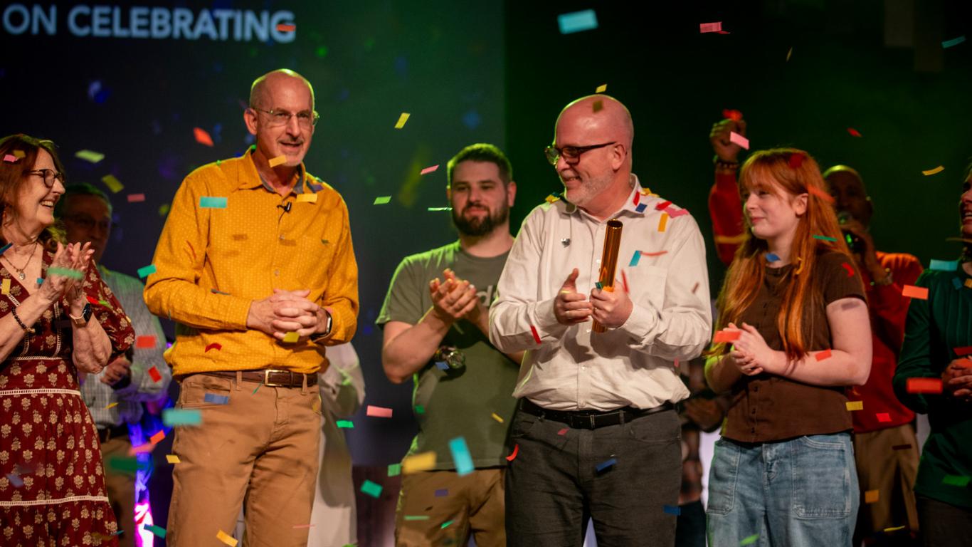 Size for blog (93) Top view of hand holding teal ribbon on dark background with copy space. Cervical and ovarian cancer, sexual assault, pcos, ptsd, anxiety disorder, agoraphobia and scleroderma awareness concept.