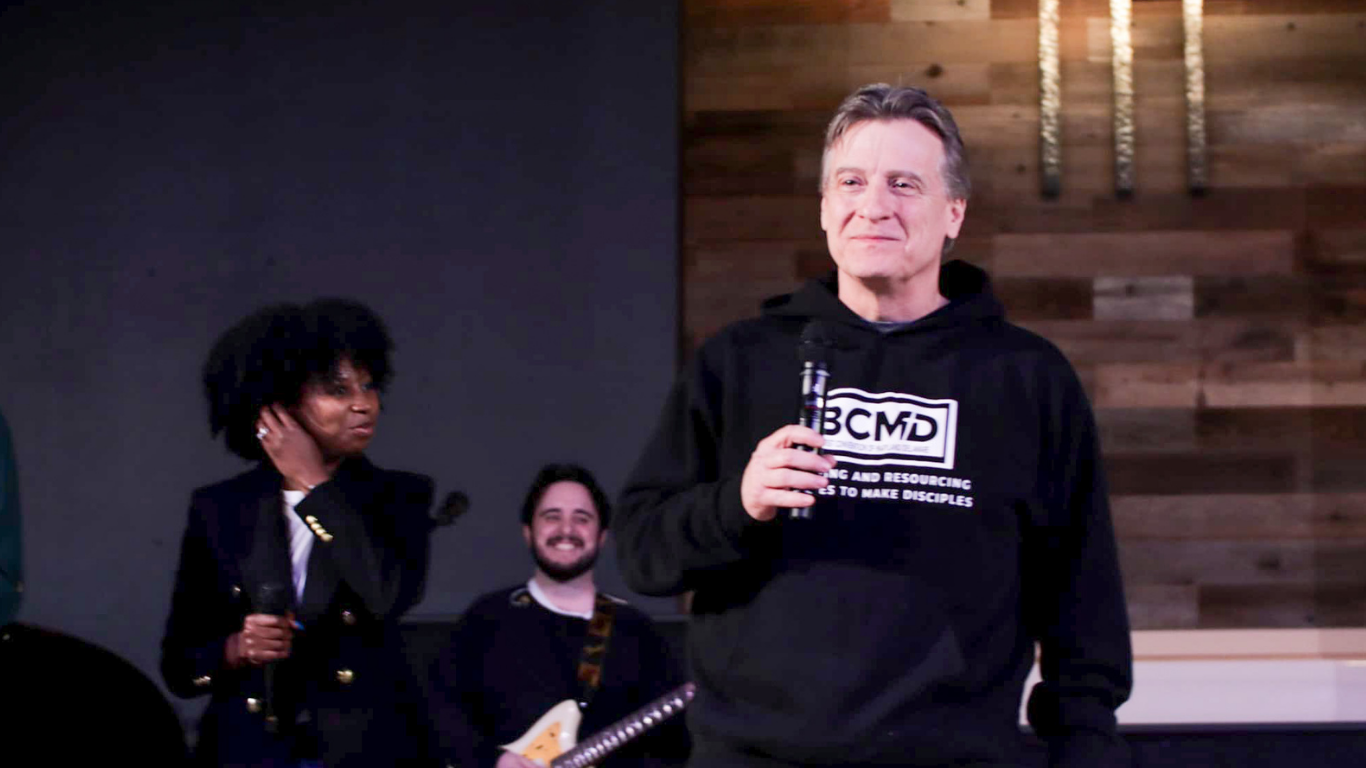 Top view of hand holding teal ribbon on dark background with copy space. Cervical and ovarian cancer, sexual assault, pcos, ptsd, anxiety disorder, agoraphobia and scleroderma awareness concept.