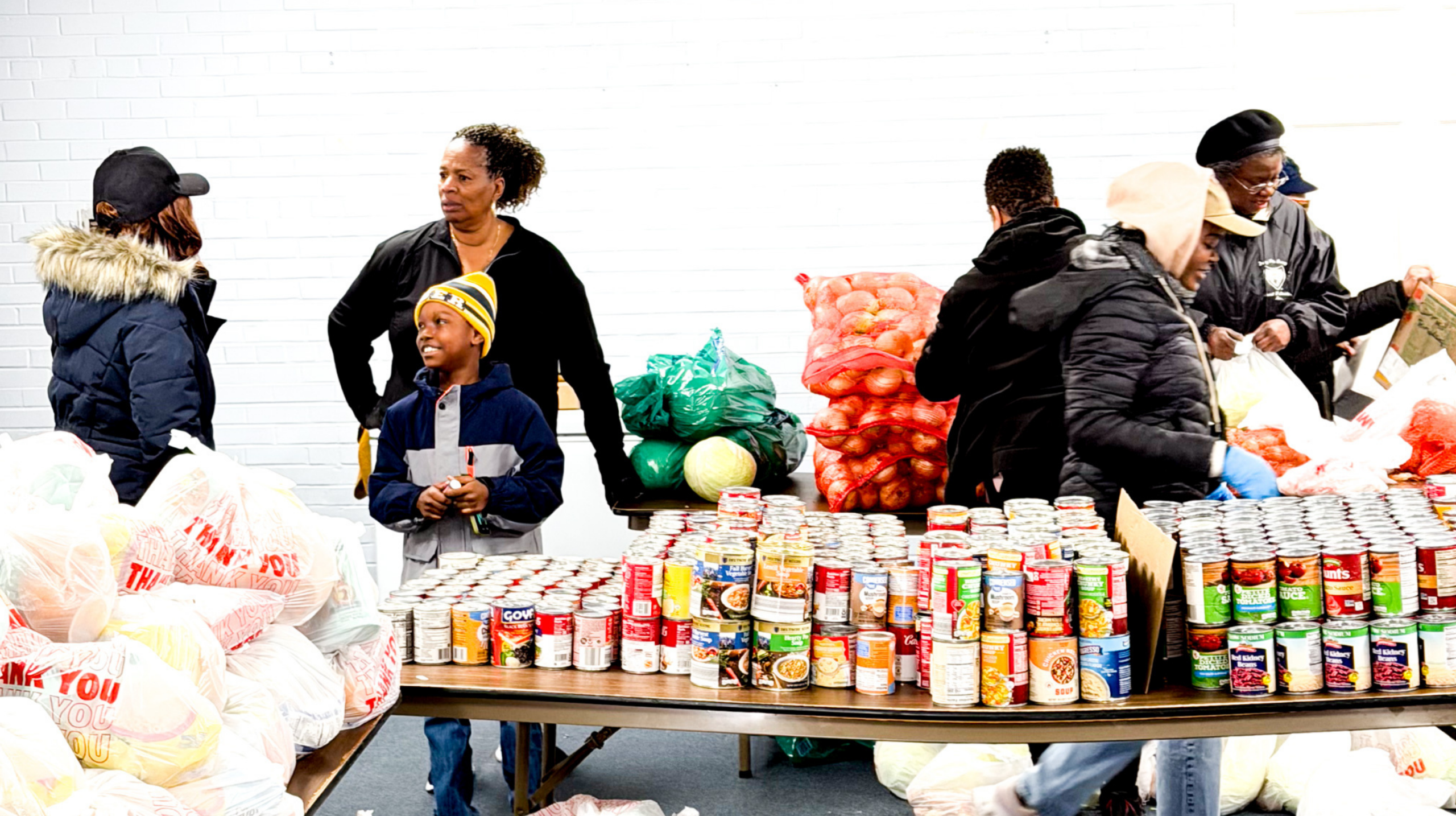 Top view of hand holding teal ribbon on dark background with copy space. Cervical and ovarian cancer, sexual assault, pcos, ptsd, anxiety disorder, agoraphobia and scleroderma awareness concept.