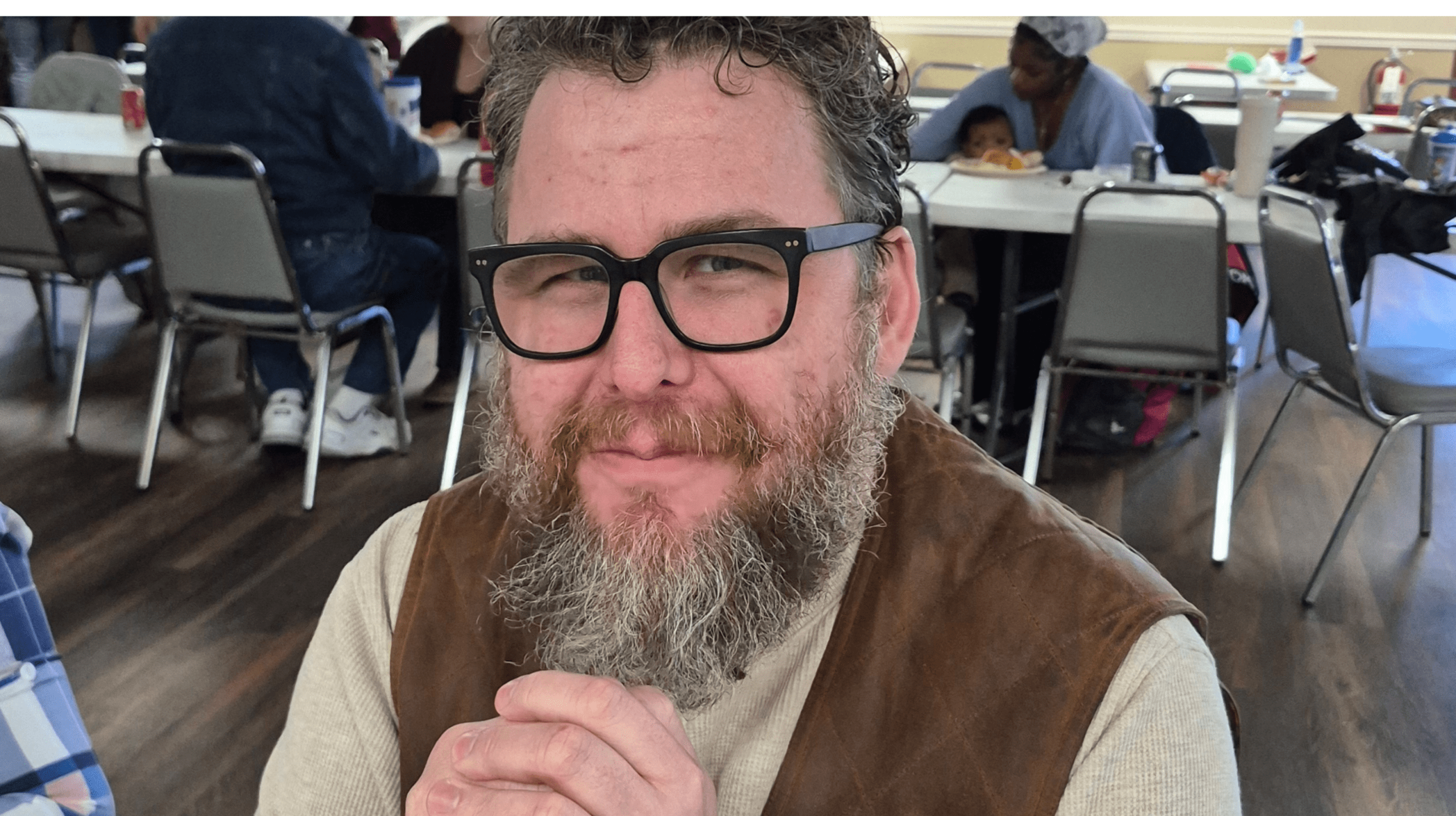 Top view of hand holding teal ribbon on dark background with copy space. Cervical and ovarian cancer, sexual assault, pcos, ptsd, anxiety disorder, agoraphobia and scleroderma awareness concept.