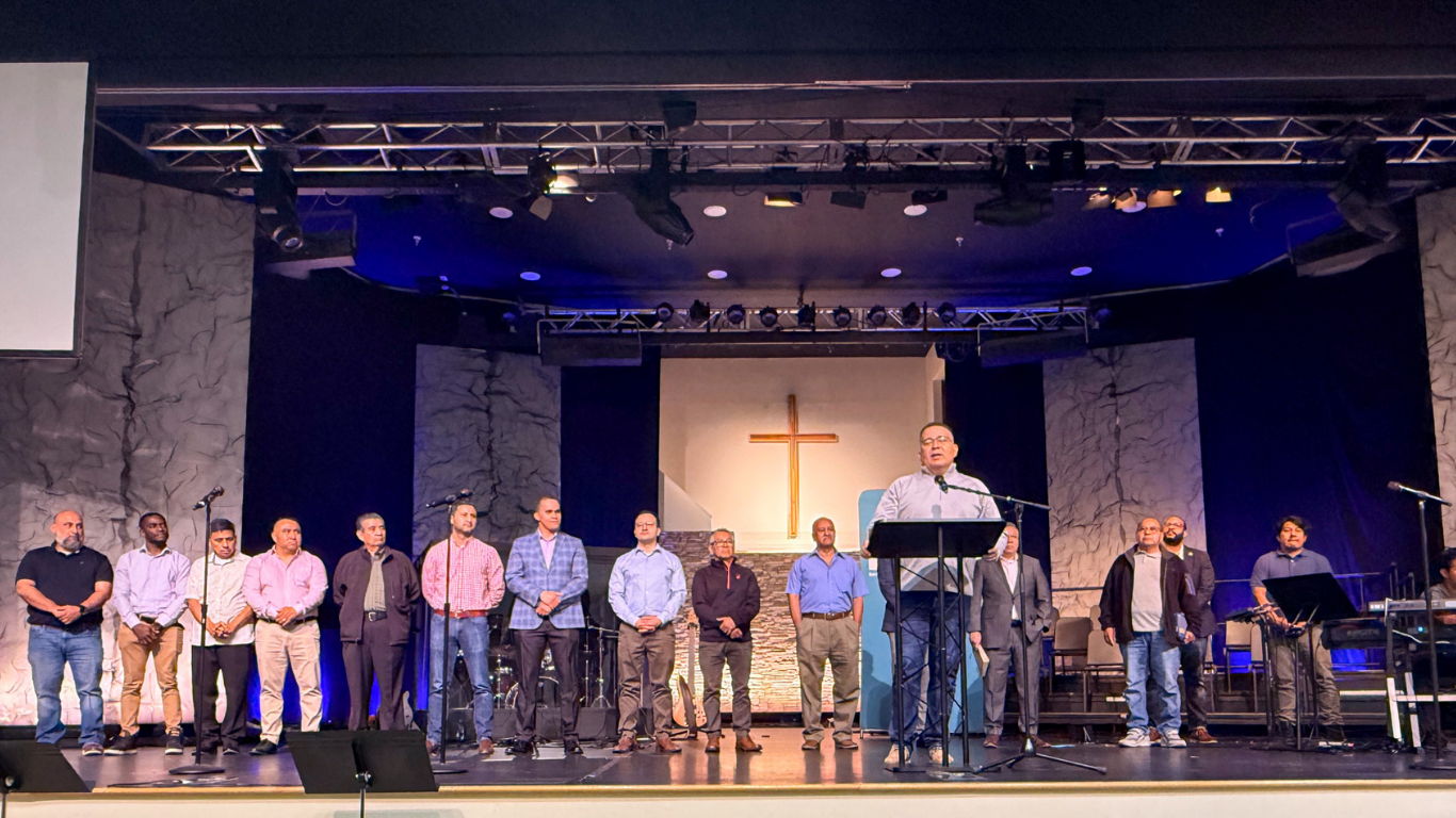 Top view of hand holding teal ribbon on dark background with copy space. Cervical and ovarian cancer, sexual assault, pcos, ptsd, anxiety disorder, agoraphobia and scleroderma awareness concept.