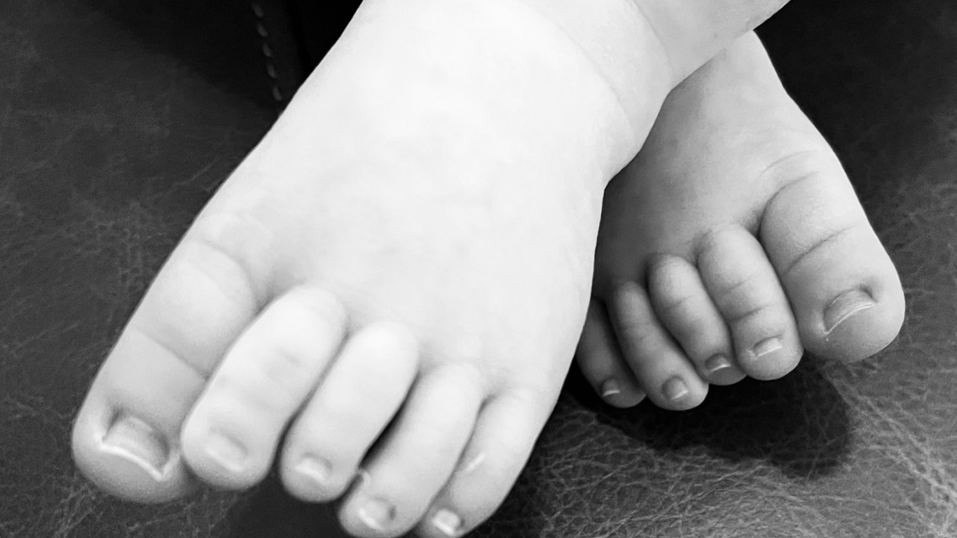 Top view of hand holding teal ribbon on dark background with copy space. Cervical and ovarian cancer, sexual assault, pcos, ptsd, anxiety disorder, agoraphobia and scleroderma awareness concept.