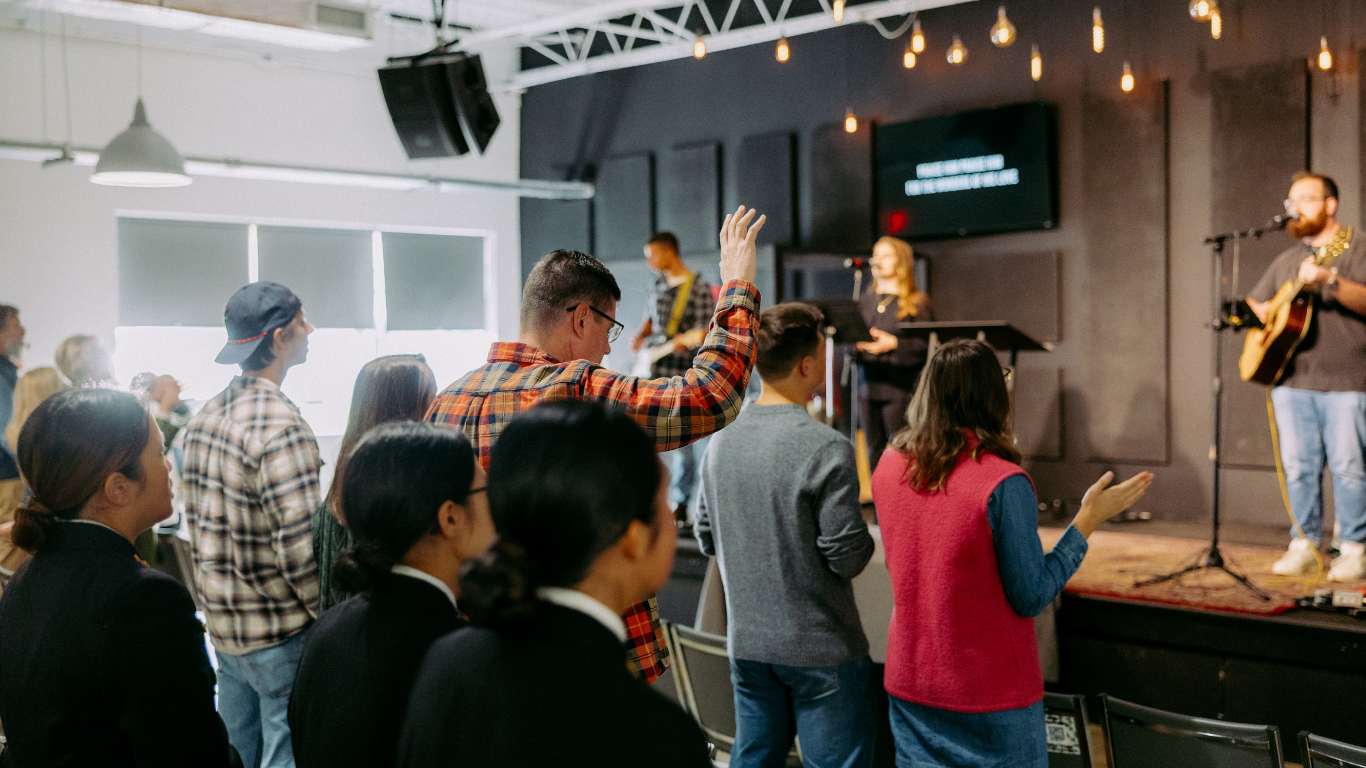 Top view of hand holding teal ribbon on dark background with copy space. Cervical and ovarian cancer, sexual assault, pcos, ptsd, anxiety disorder, agoraphobia and scleroderma awareness concept.