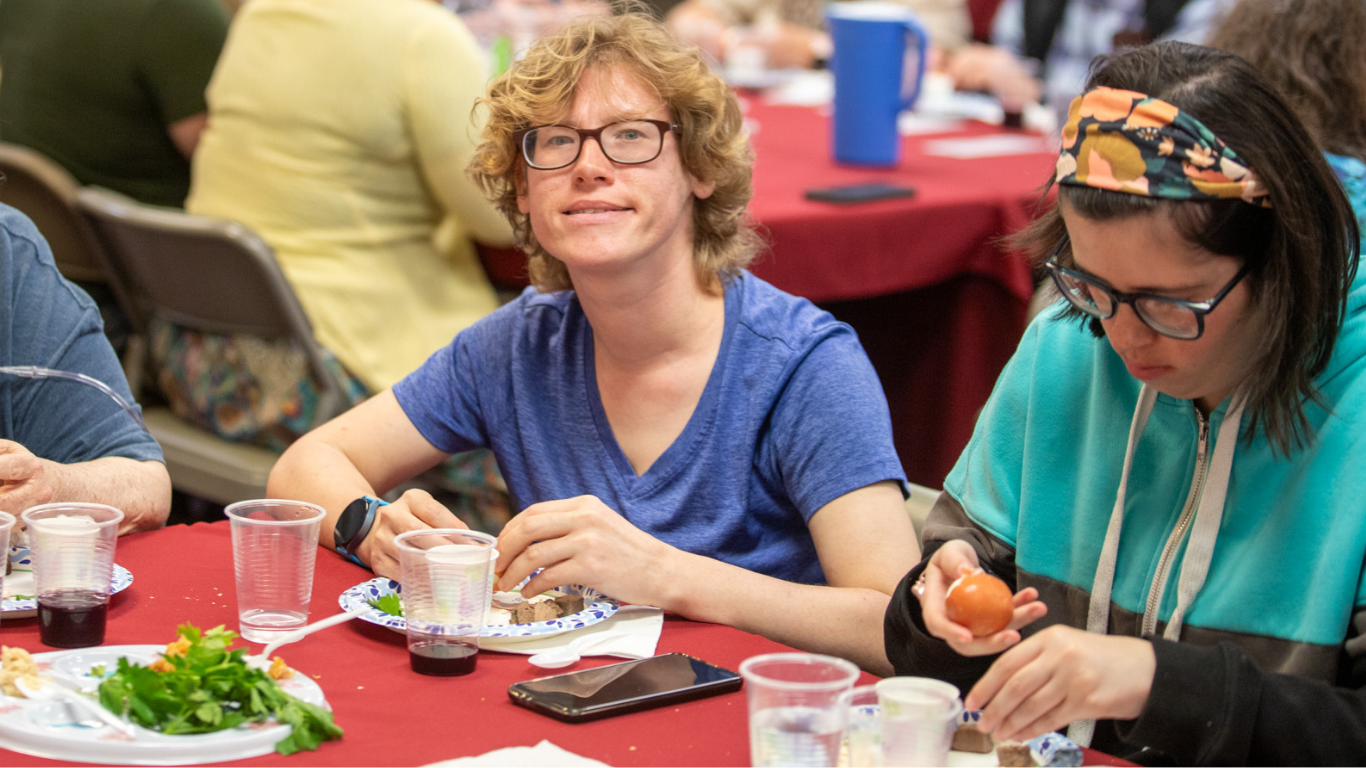 Size for blog (94) Top view of hand holding teal ribbon on dark background with copy space. Cervical and ovarian cancer, sexual assault, pcos, ptsd, anxiety disorder, agoraphobia and scleroderma awareness concept.