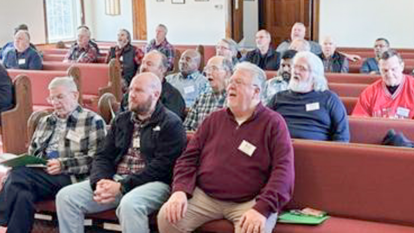 Top view of hand holding teal ribbon on dark background with copy space. Cervical and ovarian cancer, sexual assault, pcos, ptsd, anxiety disorder, agoraphobia and scleroderma awareness concept.